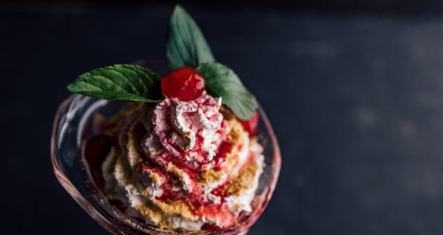Served in a cup, black background. Birthday dessert, one present from restaurant.